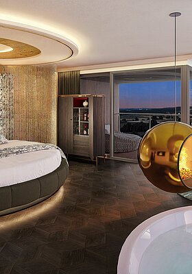 Innenansicht der Hideaway Suite mit Fokus auf das runde Bett mit gemustertem Kopfteil und indirekter Beleuchtung. Im Vordergrund ist der Whirlpool zu sehen, darüber schwebt ein goldener Design-Kamin. Große Fensterfronten bieten einen weiten Blick in die Landschaft.