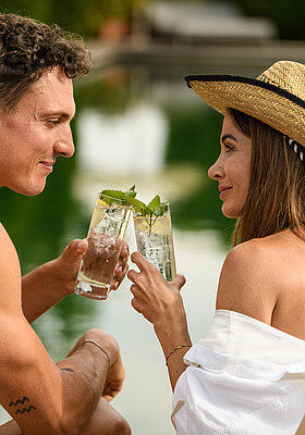 Refreshing drinks by the natural pool at the Winzer Wellness Hotel