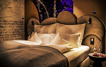 A cosy bed in a Spa Deluxe double room at the Hotel Winzer