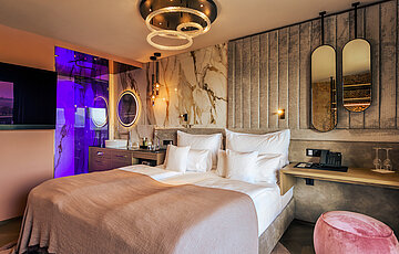 A cosy bed in the stylish Spa double room at Hotel Winzer