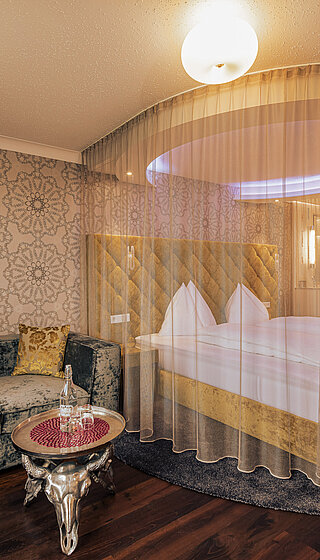 Emotion Double Room with a cosy bed at the Romantik-Wellnesshotel Winzer