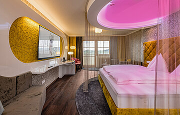 Emotion Double Room with a cosy bed at the Romantik-Wellnesshotel Winzer