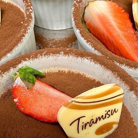 Ein Handgriff hier. Eine geschwungene Pfanne dort. Ein Lächeln, das man sogar durch den Küchendampf spürt.