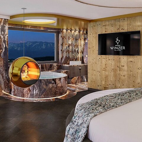 Tadaaa – wir dürfen vorstellen: Unsere Hideaway Suite. 43 m² voller Ruhe und Zweisamkeit. Rundbett. Panorama-Daybed. Runder Whirlpool für zwei. Kamin mit sanftem Effektfeuer.