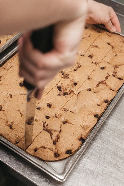 Ein Handgriff hier. Eine geschwungene Pfanne dort. Ein Lächeln, das man sogar durch den Küchendampf spürt.